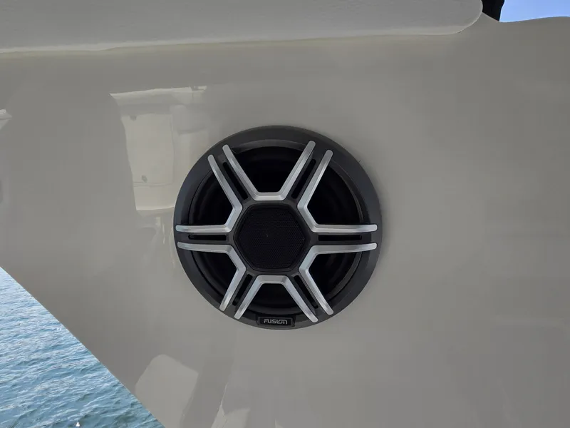 Slide: The Image of A speaker is mounted on the exterior wall of a boat, with water in the background. - 43