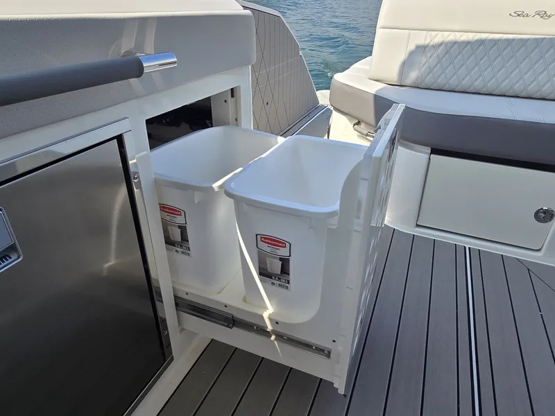 Slide: The Image of The 2027 Sea Ray SLX 400 features a pull-out trash bin on a sleek deck. - 22
