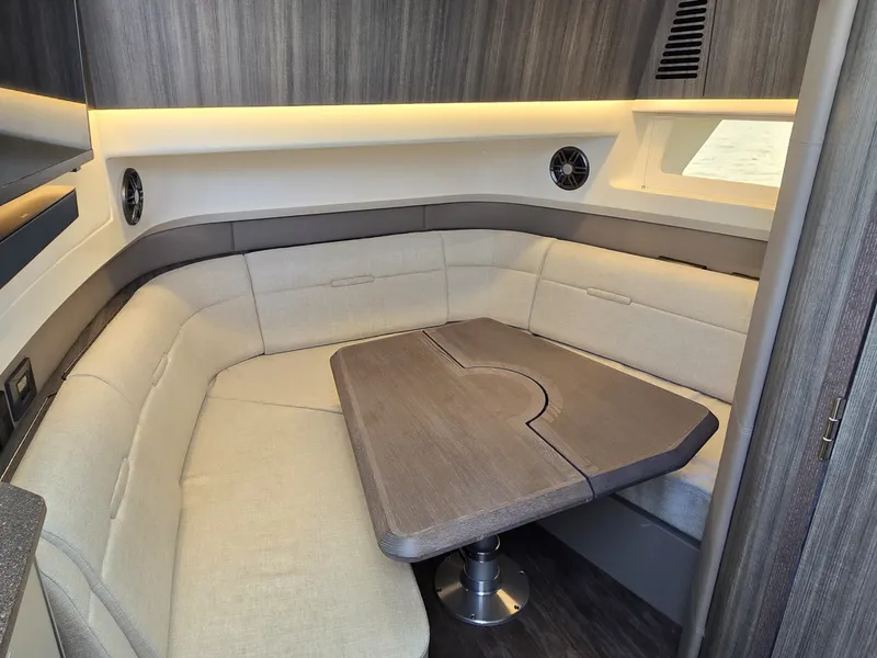Slide: The Image of Interior of the 2027 Sea Ray SLX 400 with a sleek seating area and wooden table. - 32