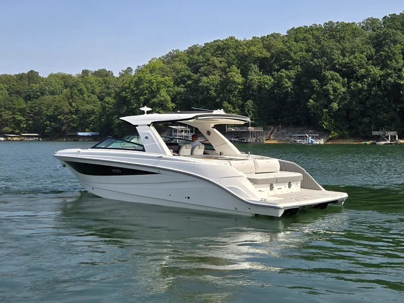 Slide: The Image of A sleek, modern boat on a calm lake, surrounded by lush trees. - 48