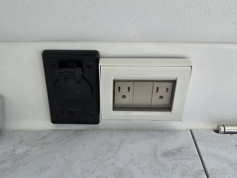 Slide: The Image of An outlet and a black connector on a boat wall. - 20