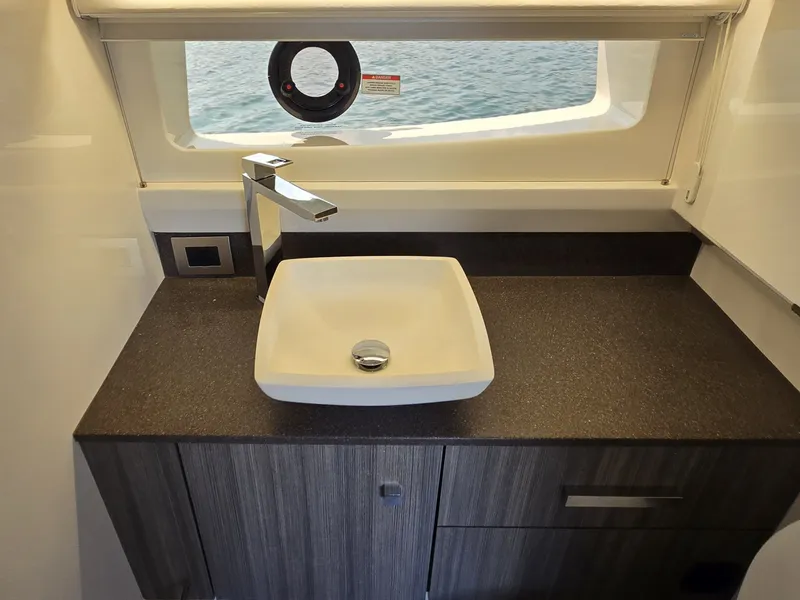 Slide: The Image of A modern sink with a square basin and stylish faucet on a dark countertop. - 39