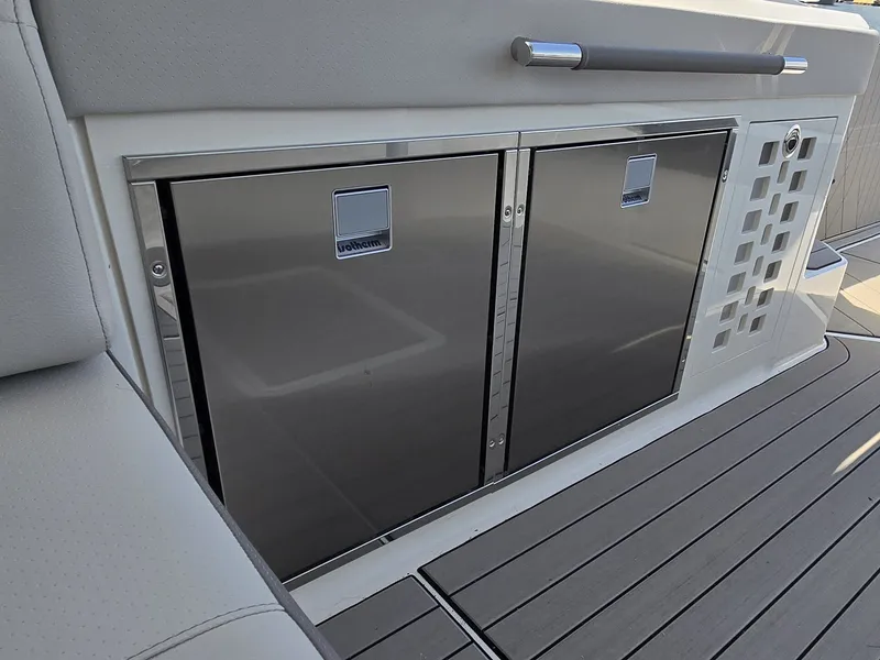 Slide: The Image of The 2027 Sea Ray SLX 400 features a sleek onboard kitchen with stainless steel refrigerators. - 21