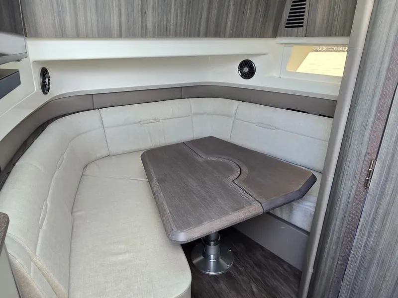 Slide: The Image of Interior of the 2027 Sea Ray SLX 400 with a sleek seating area and wooden table. - 33