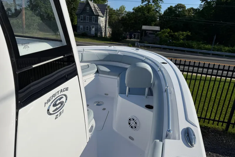 Slide: The Image of 2026 Sportsman Heritage 231 Center Console boat, sleek design, spacious seating, outdoor setting. - 7