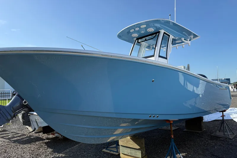 The Image of 2026 Sportsman Heritage 231 Center Console boat on display, blue hull, sunny day. - 0