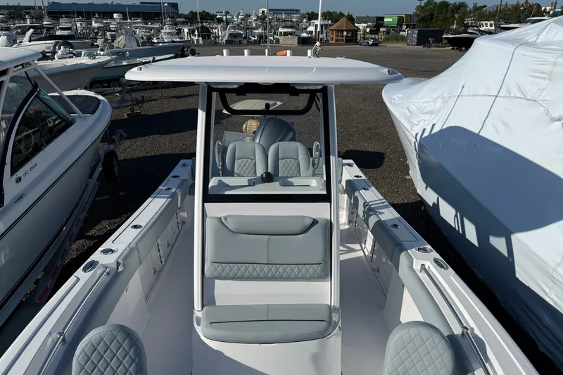 Slide: The Image of 2026 Sportsman Heritage 231 Center Console boat in marina, showcasing sleek design and seating. - 3