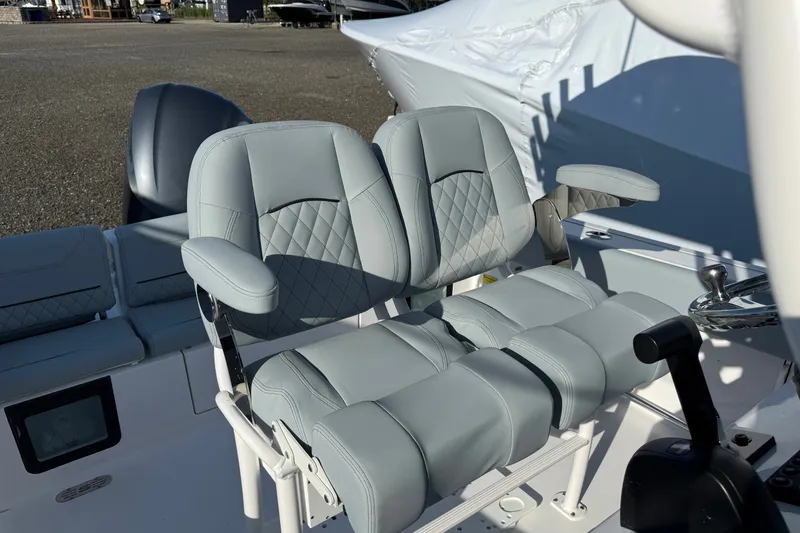 Slide: The Image of 2026 Sportsman Heritage 231 Center Console boat with luxurious dual seating and armrests. - 11