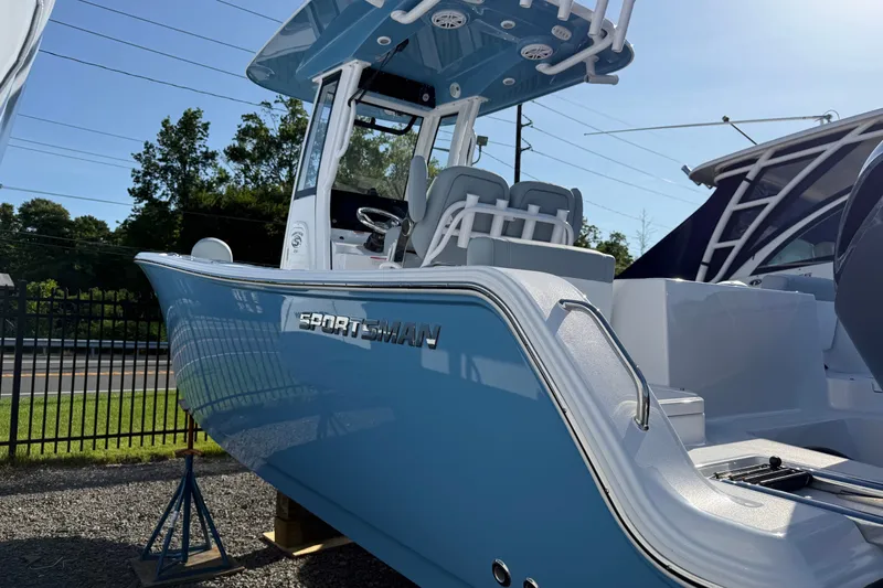 Slide: The Image of 2026 Sportsman Heritage 231 Center Console boat in blue, displayed outdoors. - 1