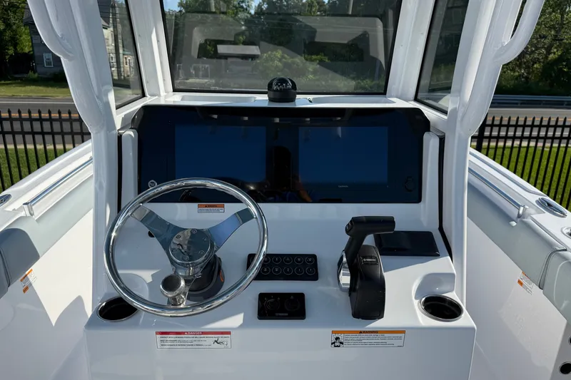 Slide: The Image of 2026 Sportsman Heritage 231 Center Console helm with steering wheel and controls. - 2