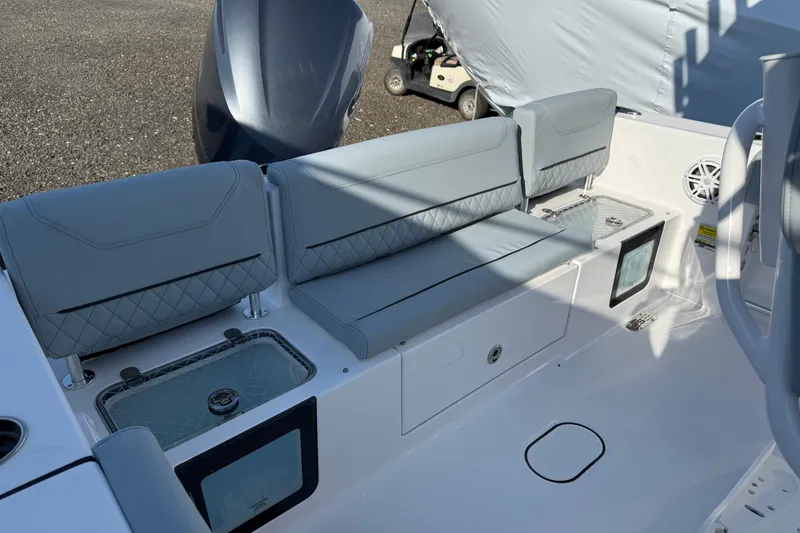 Slide: The Image of 2026 Sportsman Heritage 231 Center Console boat interior with cushioned seating and storage compartments. - 8