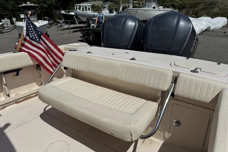 Slide: The Image of 2014 Grady-White Canyon 283 boat interior with seating and American flag. - 32