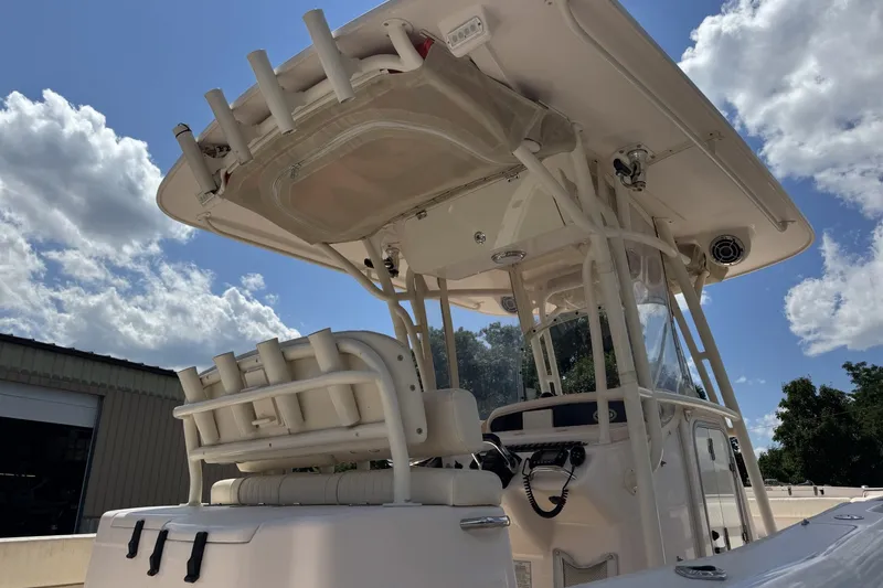 Slide: The Image of 2014 Grady-White Canyon 283 boat with T-top under a blue sky. - 25