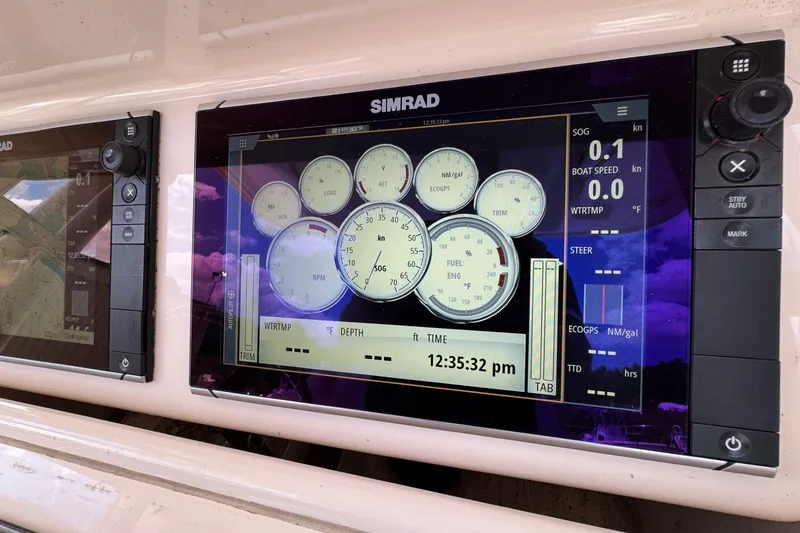 Slide: The Image of Simrad marine display on 2014 Grady-White Canyon 283 boat dashboard. - 34