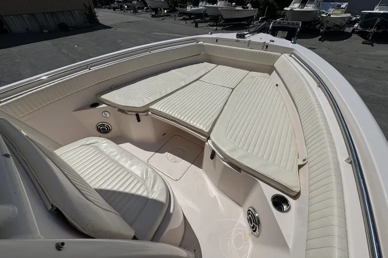 Slide: The Image of 2014 Grady-White Canyon 283 boat interior with cushioned seating and speakers. - 17
