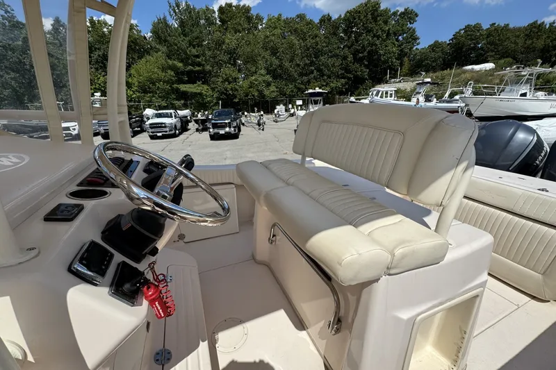 Slide: The Image of 2014 Grady-White Canyon 283 boat interior with steering wheel and seating. - 26
