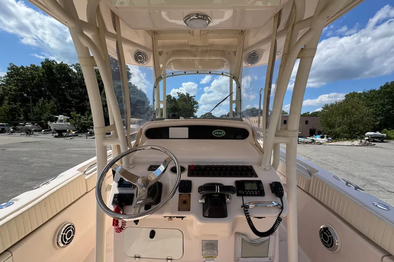 Slide: The Image of 2014 Grady-White Canyon 283 boat cockpit with steering wheel and controls. - 24