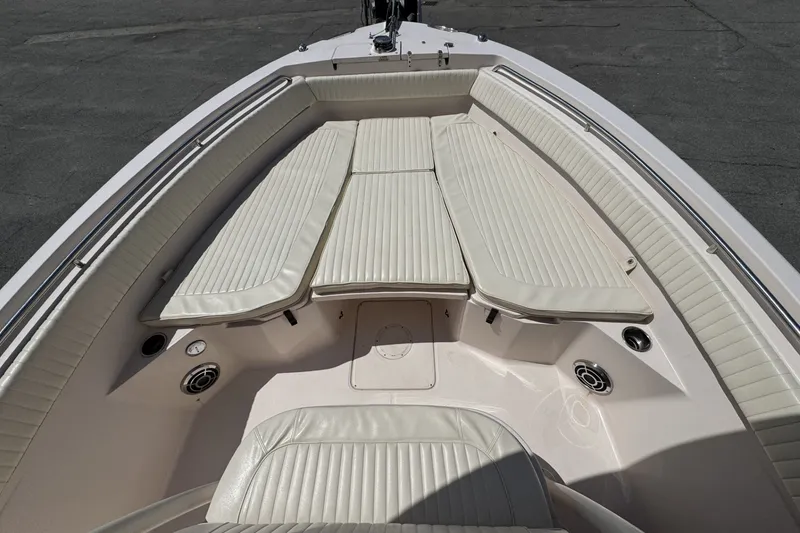 Slide: The Image of 2014 Grady-White Canyon 283 boat interior with cushioned seating and speakers. - 18
