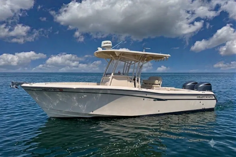 The Image of 2014 Grady-White Canyon 283 boat on calm ocean under blue sky. - 0