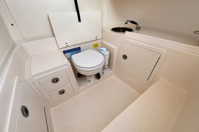 Slide: The Image of 2014 Grady-White Canyon 283 boat interior with toilet and sink. - 22