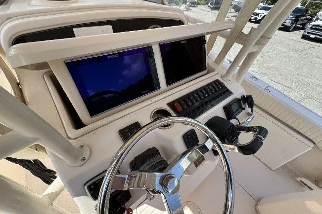 Slide: The Image of 2014 Grady-White Canyon 283 helm with dual Simrad displays and steering wheel. - 13