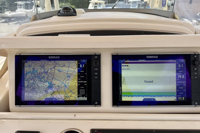Slide: The Image of Dashboard of a 2014 Grady-White Canyon 283 with dual Simrad navigation displays. - 31
