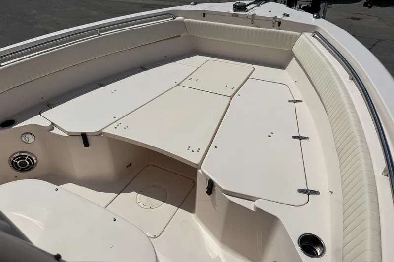 Slide: The Image of 2014 Grady-White Canyon 283 boat interior with cushioned seating and storage compartments. - 19