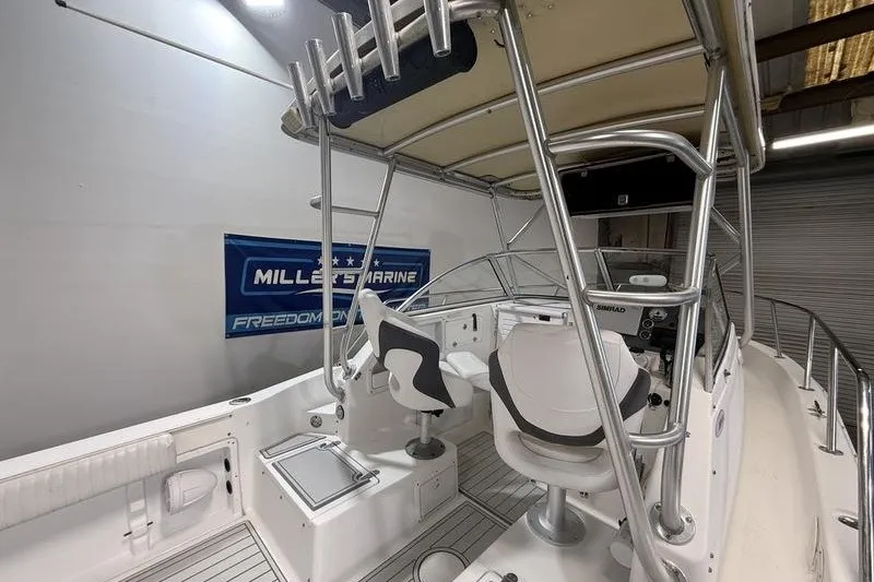 Slide: The Image of 2002 Sea Pro 235 Walk Around boat interior with seating and helm station. - 6