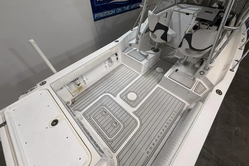 Slide: The Image of 2002 Sea Pro 235 Walk Around boat interior with seating and deck view. - 9