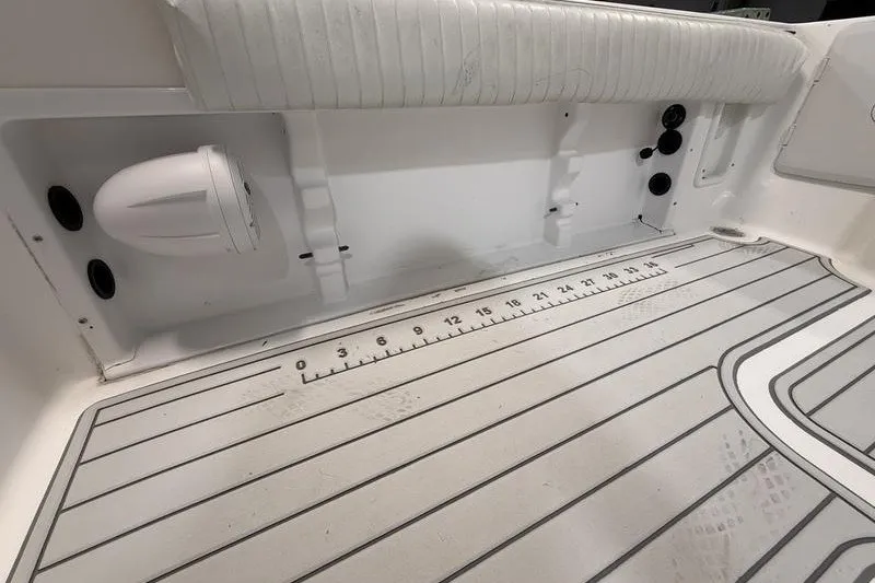 Slide: The Image of 2002 Sea Pro 235 Walk Around boat interior with striped flooring and measurement markings. - 12