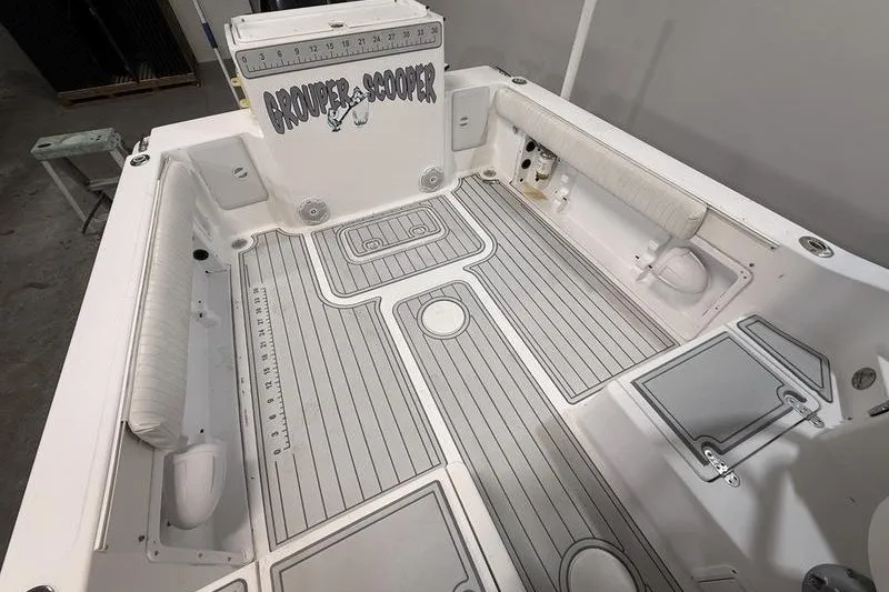 Slide: The Image of 2002 Sea Pro 235 Walk Around boat interior with custom flooring and seating. - 11