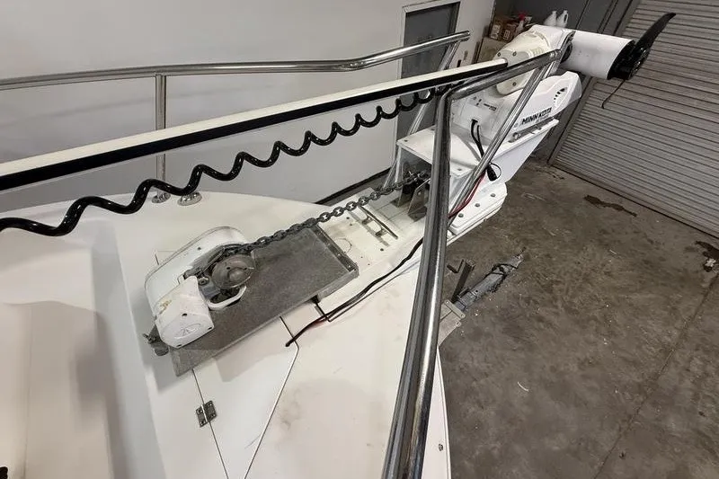 Slide: The Image of 2002 Sea Pro 235 Walk Around boat with anchor chain and motor in a garage. - 20