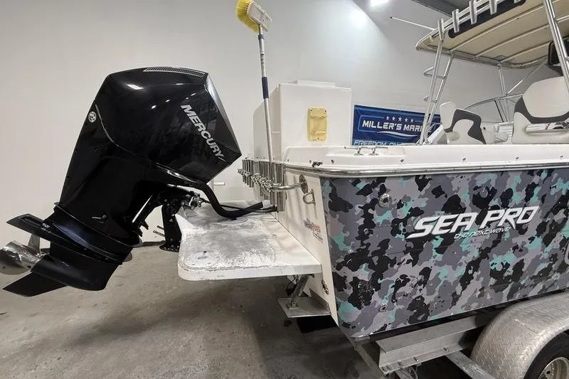 Slide: The Image of 2002 Sea Pro 235 Walk Around boat with Mercury outboard motor in a garage setting. - 4