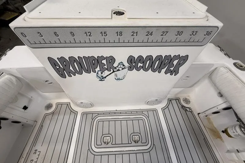 Slide: The Image of 2002 Sea Pro 235 Walk Around boat deck with "Grouper Scooper" graphic and measuring ruler. - 10