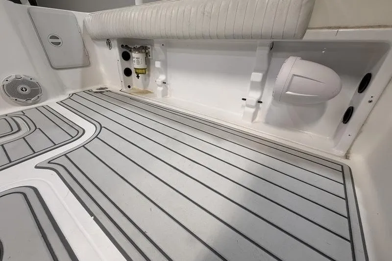 Slide: The Image of Interior view of 2002 Sea Pro 235 Walk Around boat, featuring clean deck and seating. - 13