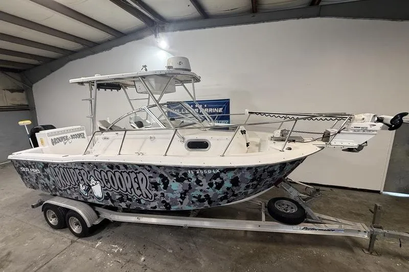 Slide: The Image of 2002 Sea Pro 235 Walk Around boat on trailer in indoor storage. - 2
