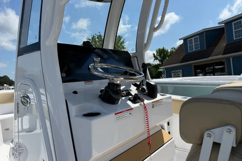 Slide: The Image of 2026 Sportsman Open 212 Center Console boat interior with steering wheel and controls. - 4