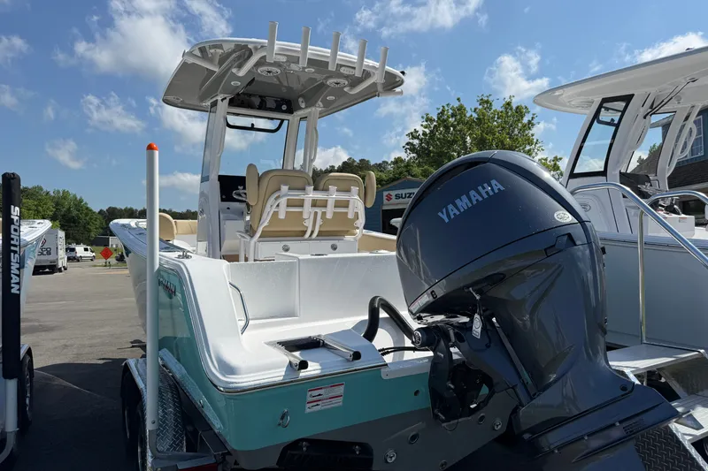 Slide: The Image of 2026 Sportsman Open 212 Center Console boat with Yamaha engine, parked outdoors. - 5