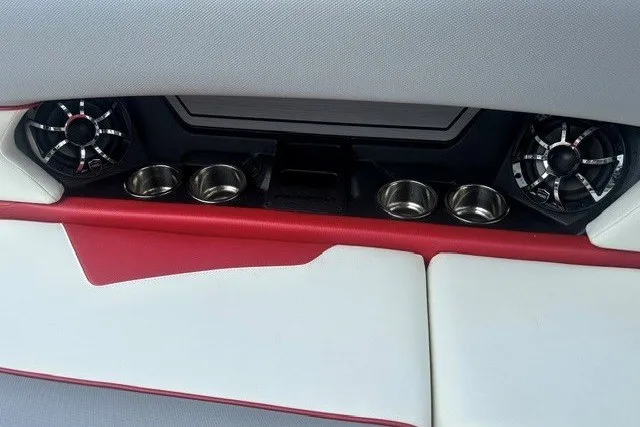 Slide: The Image of 2021 Moomba Kaiyen interior with red and white seating, cup holders, and speakers. - 16