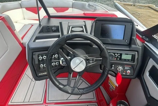 Slide: The Image of 2021 Moomba Kaiyen boat dashboard with steering wheel and control panel. - 15
