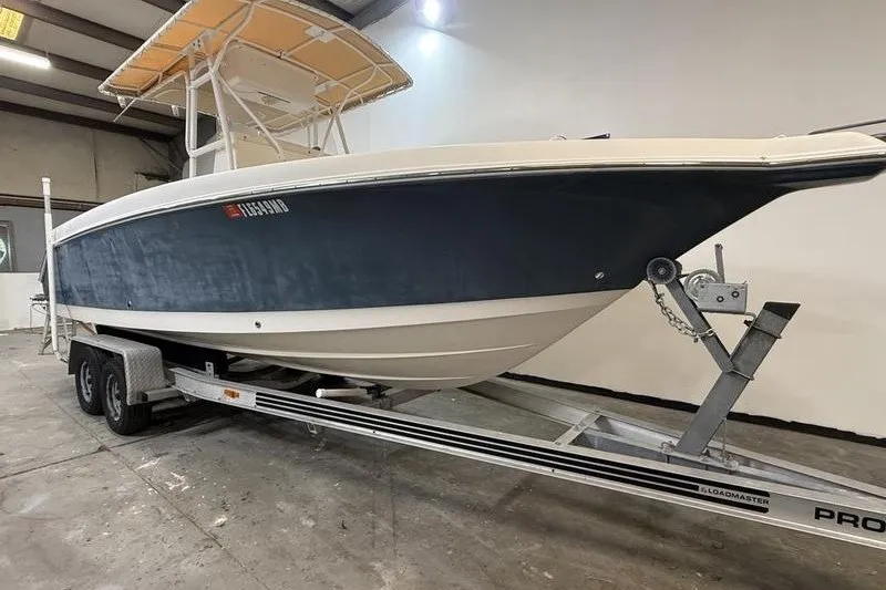 Slide: The Image of 2000 Pro-Line 23 Sport boat on trailer in indoor storage facility. - 1