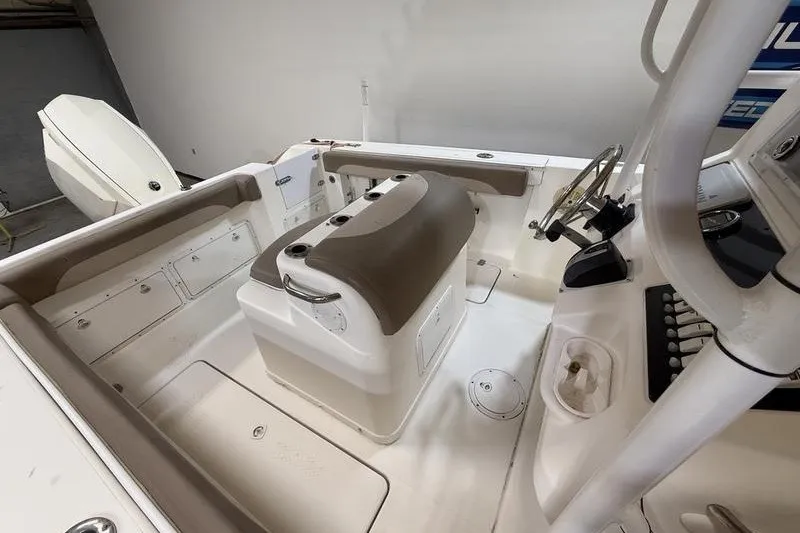 Slide: The Image of 2000 Pro-Line 23 Sport boat interior with helm, seating, and storage compartments. - 12