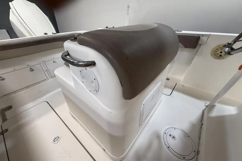 Slide: The Image of 2000 Pro-Line 23 Sport boat interior with cushioned seating and storage compartments. - 11