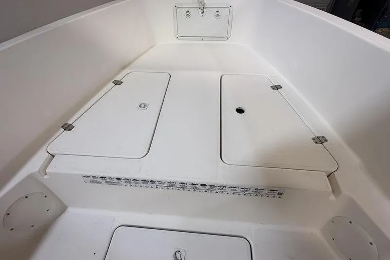 Slide: The Image of 2000 Pro-Line 23 Sport boat interior with storage compartments and clean white finish. - 17