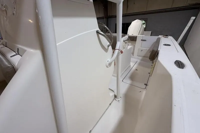 Slide: The Image of 2000 Pro-Line 23 Sport boat interior with steering wheel and seating area. - 13