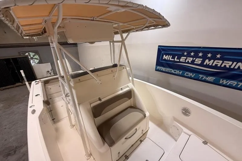 Slide: The Image of 2000 Pro-Line 23 Sport boat interior with seating and canopy, displayed at Miller's Marine. - 15