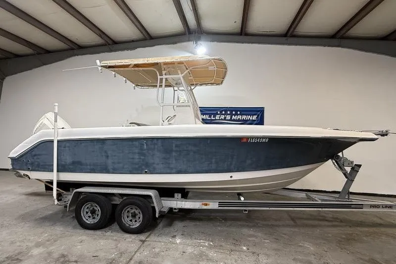 The Image of 2000 Pro-Line 23 Sport boat on trailer in indoor storage facility. - 0