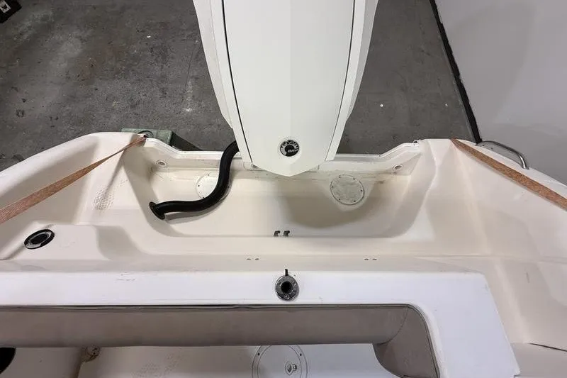 Slide: The Image of 2000 Pro-Line 23 Sport boat interior, featuring a clean, white deck and storage area. - 5
