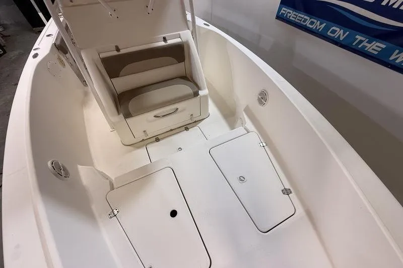 Slide: The Image of 2000 Pro-Line 23 Sport boat interior with seating and storage compartments. - 16