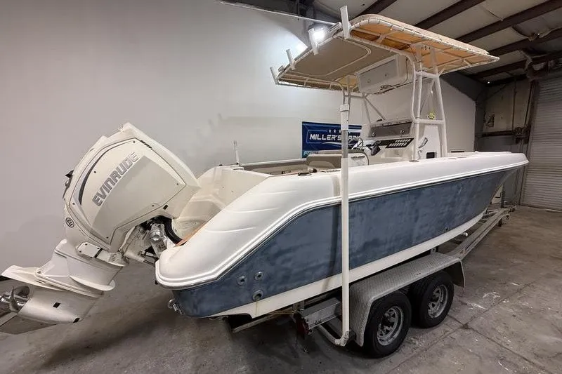 Slide: The Image of 2000 Pro-Line 23 Sport boat with Evinrude engine on trailer in garage. - 3
